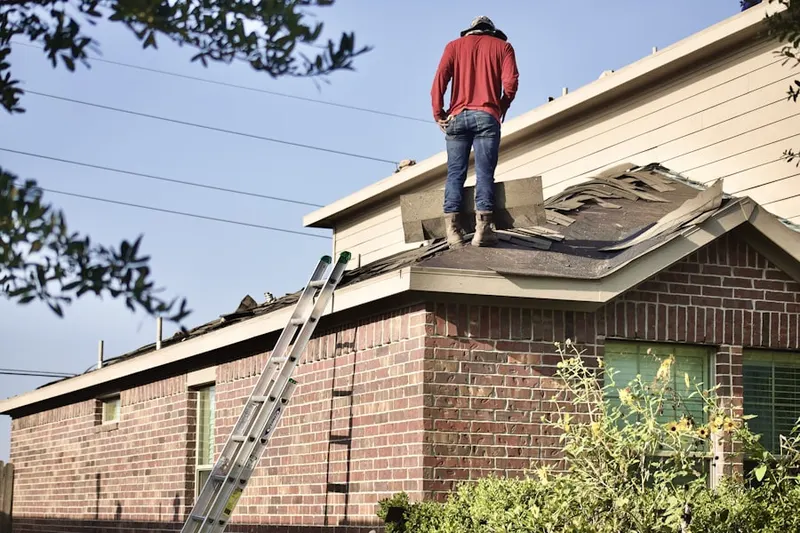 Professional roofer working on a residential roof in Mt. Airy